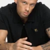 Polo Walter nera con pannelli in maglia aperta e motivo pointelle